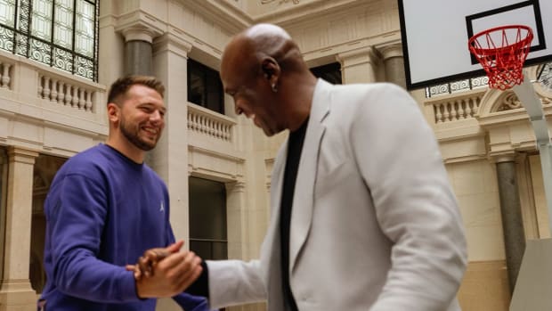 Luka Doncic shakes hands with Michael Jordan.